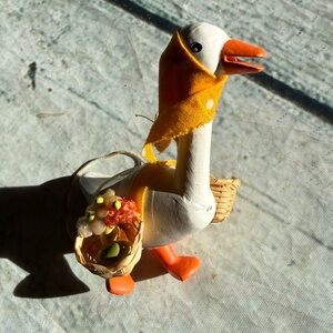 Vintage mother goose carrying baskets with eggs ornament.